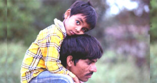 On father's shoulder