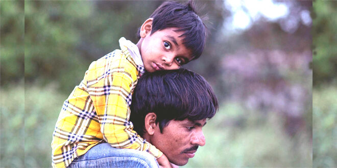 On father's shoulder